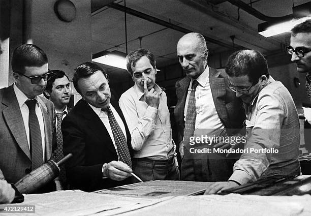 "Italian journalist and editor in chief of Il Giornale Nuovo Indro Montanelli looking at the proof of the first page of the newspaper with Italian...