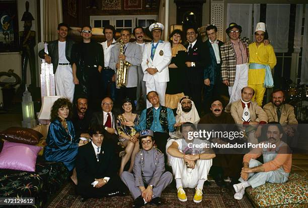 "The cast of the TV variety show Quelli della notte posing smiling for a group photo. There are Italian musician and TV host Renzo Arbore, Italian...