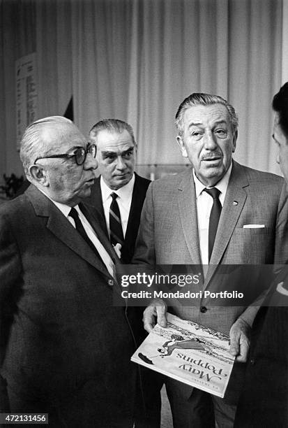 "American cartoonist, animator, dubber, film producer, director and scriptwriter Walt Disney visiting the exhibition Salone del Bambino with Italian...