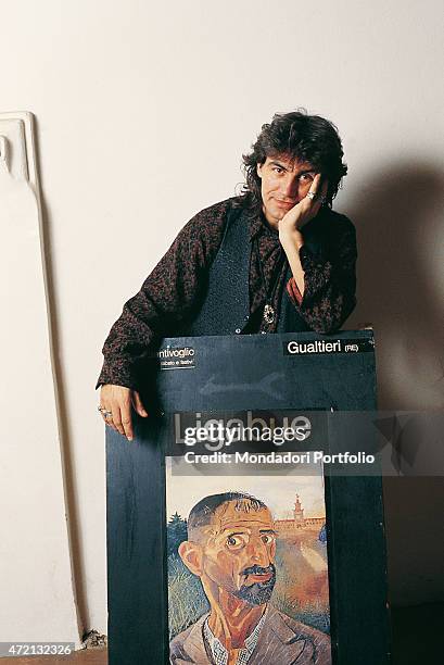 "Italian singer-songwriter Luciano Ligabue posing resting his arms on the advertising poster dedicated to the painter Ligabue in a photocall shooted...