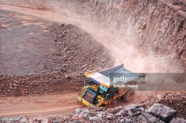 dumper truck on road in surface mine quarry - open pit mine stock pictures, royalty-free photos & images