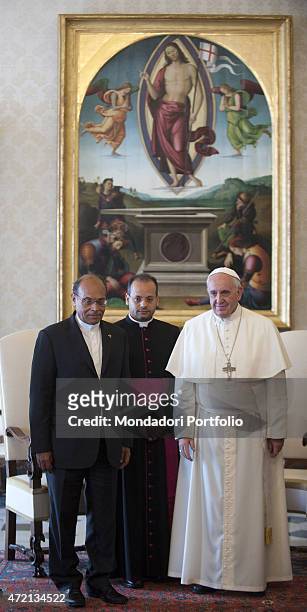"Pope Francis welcoming the President of the Republic of Tunisia Moncef Marzouki at the private library of the Apostolic Palace. Behind them, the...