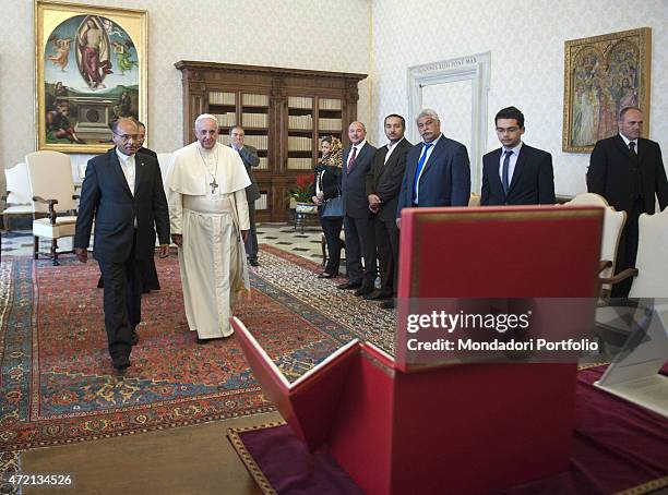 "Pope Francis meeting the President of the Republic of Tunisia Moncef Marzouki at the private library of the Apostolic Palace. Behind them, the...