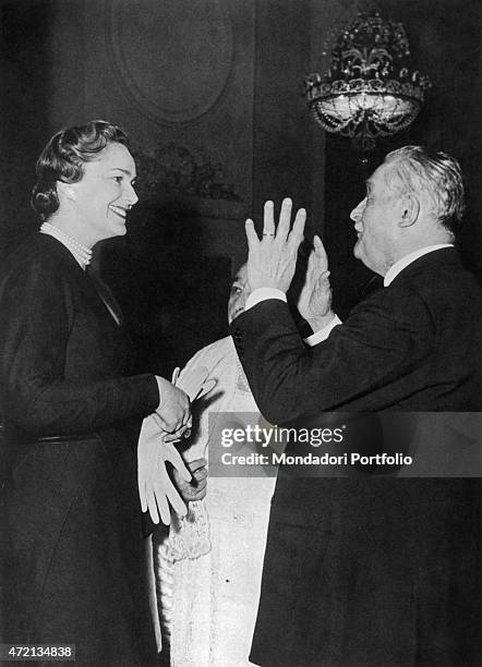 "French model Begum Om Habibeh Aga Khan , fourth wife of Imam of the Nizari Ismaili community Aga Khan III, smiling in front the owner of the casino...