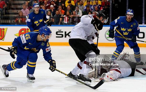 Edgars Masalskis, goaltender of Latvia covers the puck during the IIHF World Championship group A match between Latvia and Sweden at o2 Arena on May...