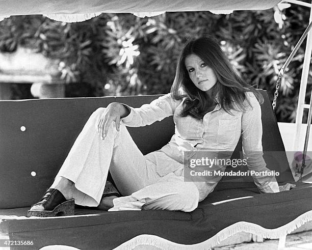 "Italian actress Stefania Sandrelli posing seated on a swing. Rome, 1970s "