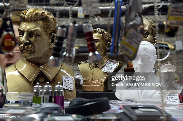 Busts of late Soviet leader Joseph Stalin and Russian President Vladimir Putin are displayed on a shelf in a souvenir shop in central Moscow on May...