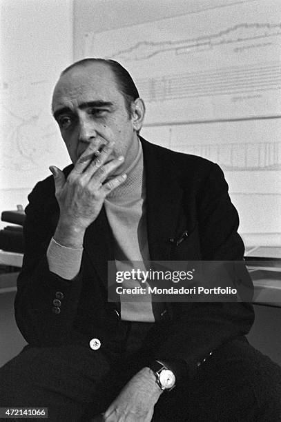 "Brazilian architect Oscar Niemeyer smoking a cigarette in his studio. The Italian publisher Giorgio Mondadori has recently commissioned the...