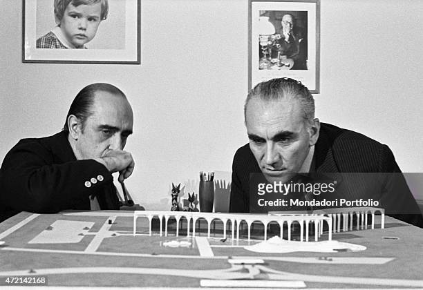 "Brazilian architect Oscar Niemeyer and Italian publisher Giorgio Mondadori seeing the Palazzo Mondadori scale model. The Italian publisher Giorgio...