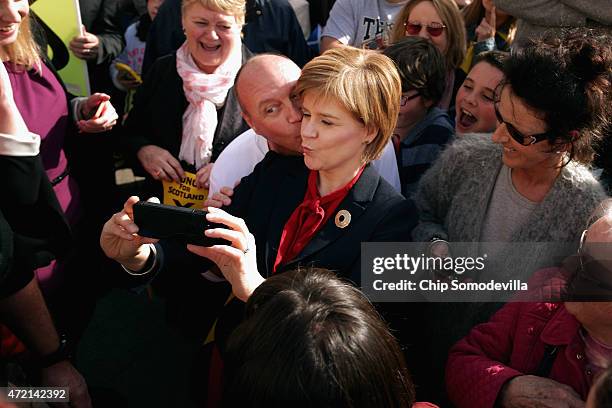 First Minister and leader of the Scottish National Party Nicola Sturgeon poses for a 'selfie' while wading through a crowd of hundreds of supporters...