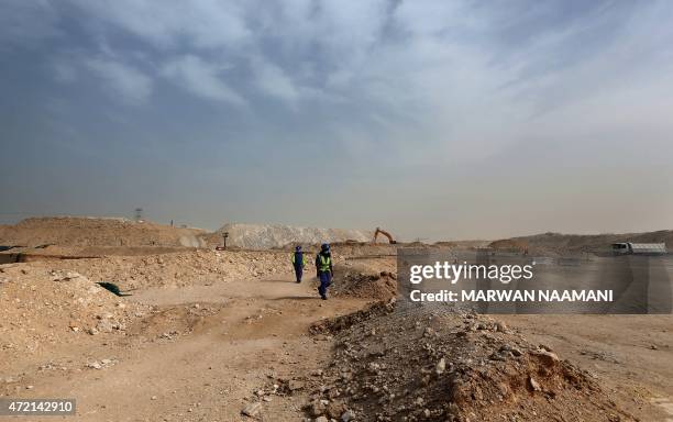 Foreign laborers work at the construction site of the al-Wakrah football stadium, one of the Qatar's 2022 World Cup stadiums, on May 4 in Doha's...