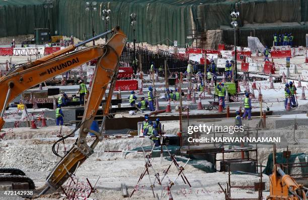 Foreign laborers work at the construction site of the al-Wakrah football stadium, one of the Qatar's 2022 World Cup stadiums, on May 4 in Doha's...