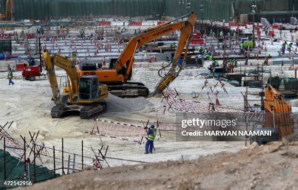 Foreign laborers work at the construction site of the al-Wakrah football stadium, one of the Qatar's 2022 World Cup stadiums, on May 4 in Doha's...