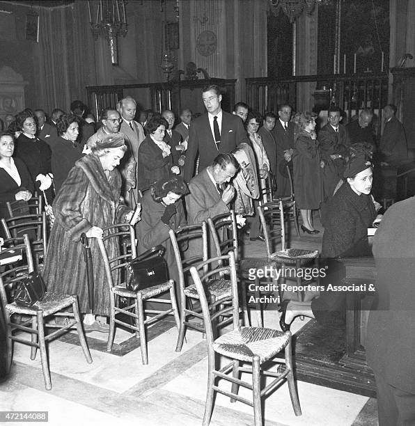 American actor Gary Cooper praying at Cappuccini's church on via Veneto in Rome with his wife Veronica Balfe and their daughter Maria Cooper. Rome,...