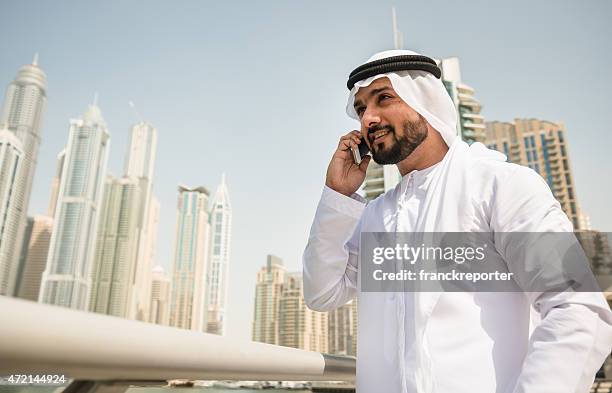 global communications in the arabic country - djellaba stockfoto's en -beelden