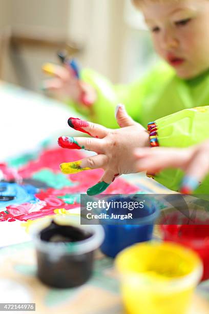 child painting with colorful fingerpaint - kids arts and crafts stock pictures, royalty-free photos & images