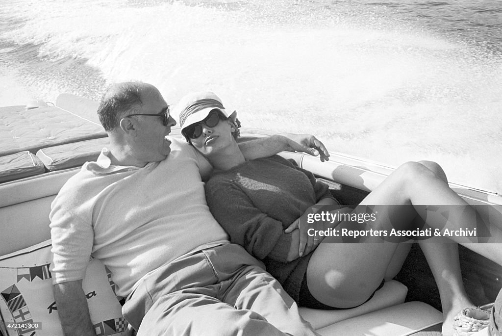 Sofia Loren and Carlo Pondi hugging each other on the motorboat