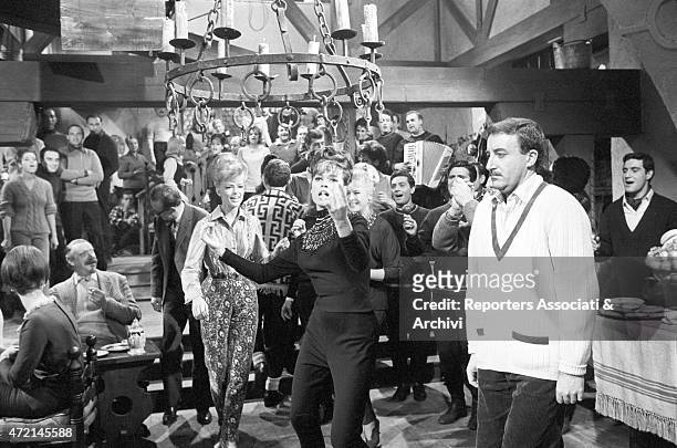American actress Fran Jeffries singing and dancing, involving the British actor Peter Sellers following her clumsily, in a scene from the film 'The...