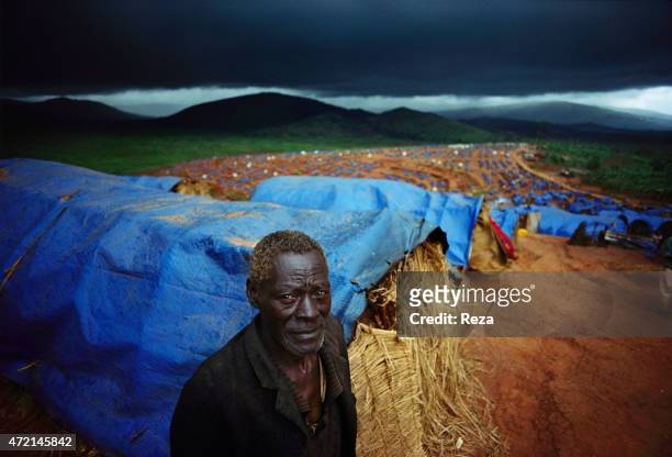 Kanague Camp, Lake Cyohoha, Rwanda. During the Rwandan Genocide, in a refugee camp, a Burundian Hutu man wanders around the tents.
