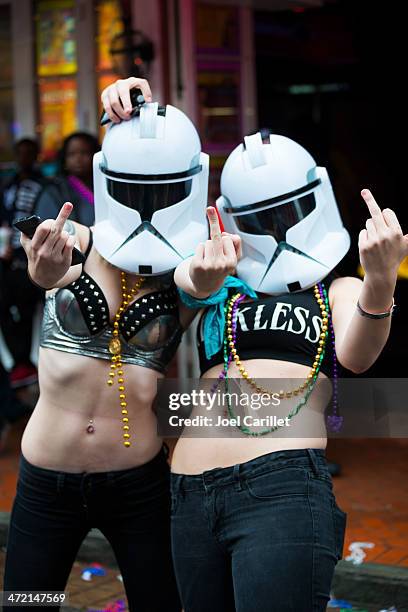 women wearing stormtrooper masks and middle finger at mardi gras - stormtrooper costume stock pictures, royalty-free photos & images