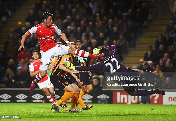 Mesut Oezil of Arsenal challenges goalkeeper Steve Harper of Hull City during the Barclays Premier League match between Hull City and Arsenal at KC...