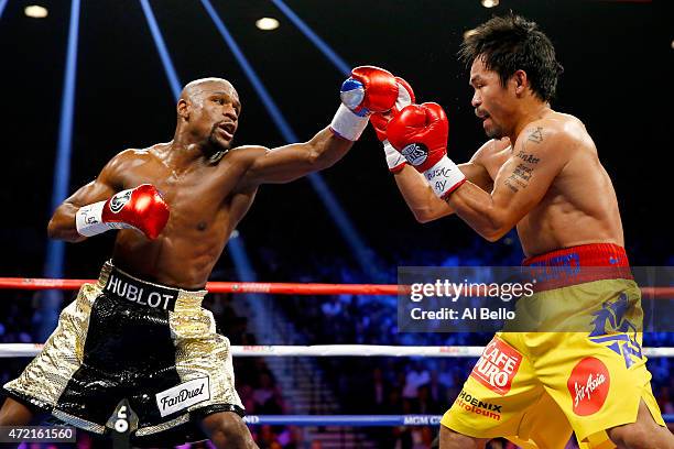 Floyd Mayweather Jr. Throws a left at Manny Pacquiao during their welterweight unification championship bout on May 2, 2015 at MGM Grand Garden Arena...