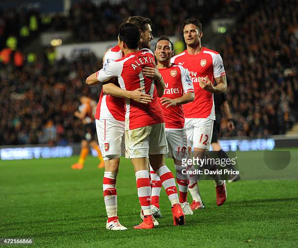 Alexis Sanchez celebrates scoring Arsenal's 3rd goal with Aaron Ramsey during the match between Hull City and Arsenal at KC Stadium on May 4, 2015 in...