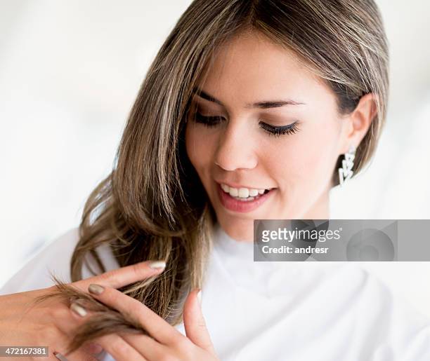 woman looking at her hair - adjusting hair stock pictures, royalty-free photos & images