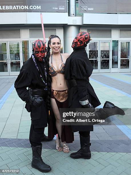 Cosplayer dressed as Slave Leia from 'Return of the Jedi' with a set of Darth Mauls on Day Four of Disney's 2015 Star Wars Celebration held at the...