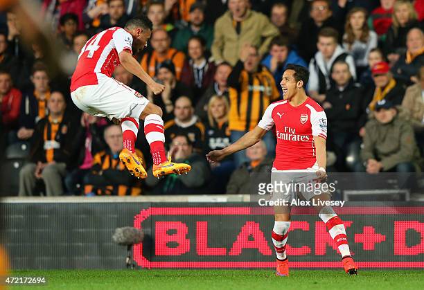 Alexis Sanchez of Arsenal celebrates with Francis Coquelin after scoring their first goal during the Barclays Premier League match between Hull City...
