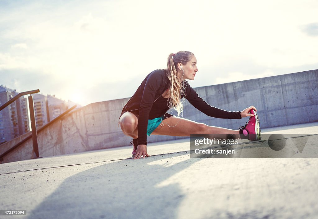 Exercising young woman outdoors