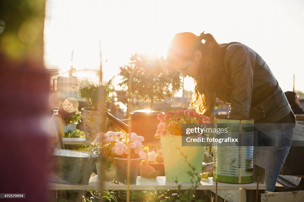 Young woman in urban gardening project at raised bed
