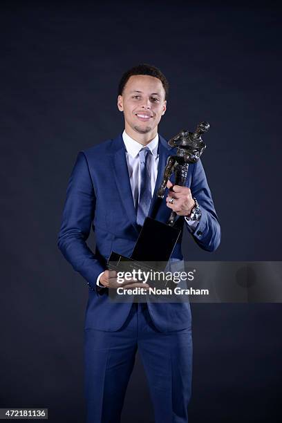 Stephen Curry of the Golden State Warriors poses for a portrait with the Maurice Podoloff Trophy at the 2014-15 KIA Most Valuable Player Award Press...