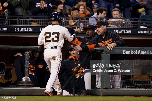 Nori Aoki of the San Francisco Giants is congratulated by manager Bruce Bochy after scoring a run against the San Diego Padres during the third...