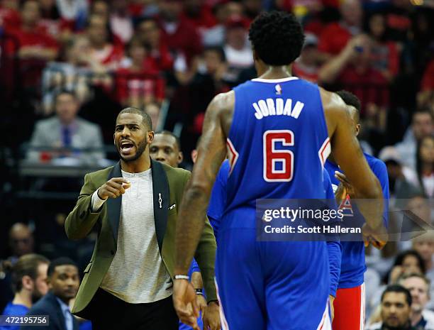 Chris Paul of the Los Angeles Clippers greets DeAndre Jordan near the bench late in their game against the Houston Rockets during Game One in the...