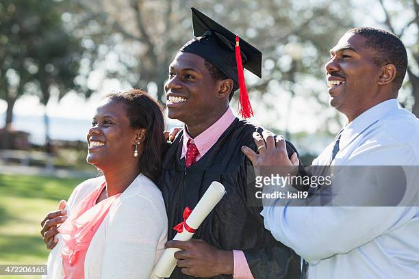 african american graduate with proud parents - son graduation stock pictures, royalty-free photos & images