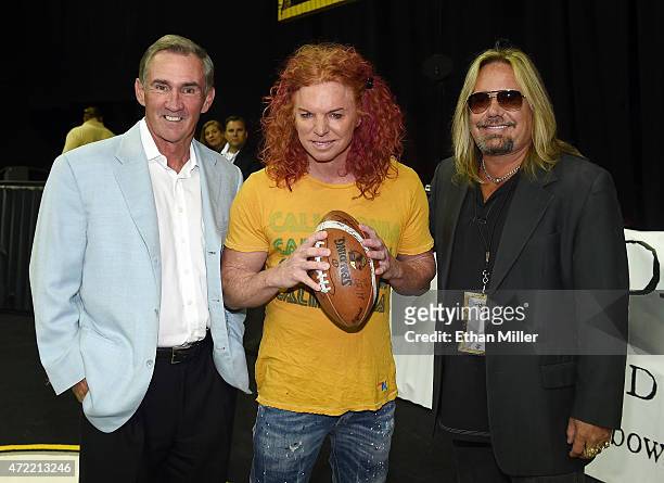 Former NFL coach Mike Shanahan, comedian Carrot Top and Motley Crue singer and Las Vegas Outlaws owner Vince Neil pose before the Outlaws' game...
