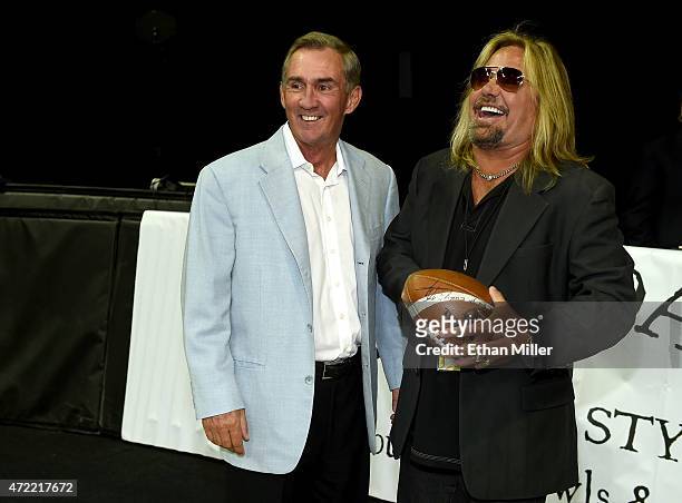 Former NFL coach Mike Shanahan and Motley Crue singer and Las Vegas Outlaws owner Vince Neil laugh before the Outlaws' game against the Los Angeles...