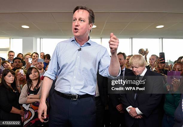 Prime Minister David Cameron speaks as London Mayor Boris Johnson looks on at an election rally in Hendon on May 5, 2015 in Twickenham, London....