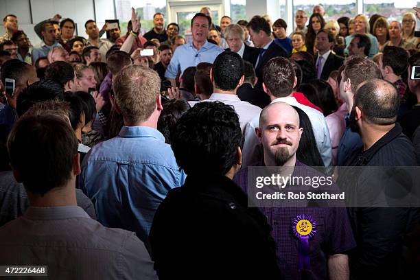 Man wearing a UK Independence Party rosette is seen amongst a crowd of staff attending a speech by Prime Minister David Cameron at Utility Warehouse...