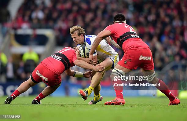 Aurelien Rougerie of Clermont is tackled by Alexandre Menini of Toulon and Romain Taofifenua of Toulon during the European Rugby Champions Cup Final...