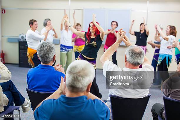 giving accompaniment to professional belly dancer - belly dancer stockfoto's en -beelden