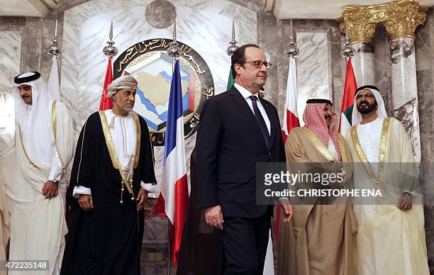 French President Francois Hollande walks past Kuwaiti Foreign Minister Sheikh Sabah Khalid Al Hamad Al Sabah, Omani representative of the Sultan...