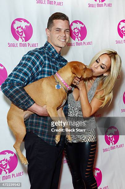 Steven Simpson, Playboy model Shauna Sand and their dog Buddha arrive at Single Mom Planet 2015 Mom Awards Dinner at Maggiano's at The Grove on May...