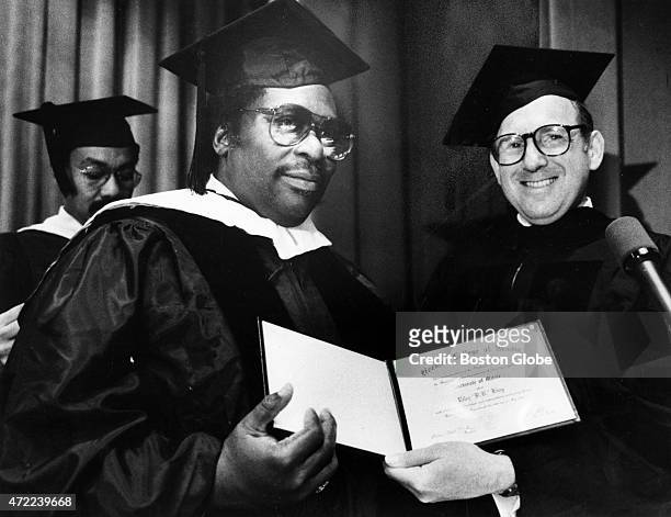 King, left, receives an honorary doctor of music degree from Berklee College of Music president Lee Eliot Berk during Berklee's commencement ceremony...