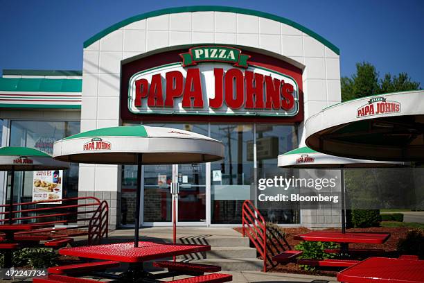 Umbrellas and outdoor seating stand outside a Papa John's International Inc. Restaurant in Louisville, Kentucky, U.S., on Friday, May 1, 2015. Papa...