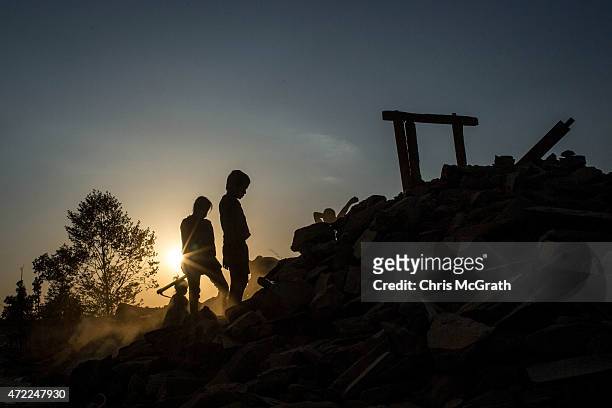 People sort through the rubble of their home looking for any salvageable item in Jalkini on May 5, 2015 in Kathmandu, Nepal. A major 7.9 earthquake...