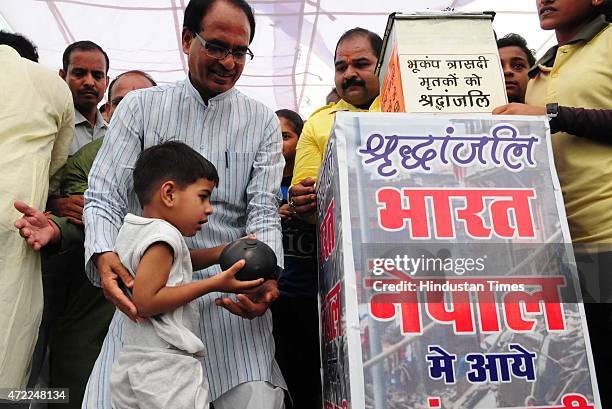 Three and half year old Prateek Soni handing over his piggy bank to chief minister Shivraj Singh Chouhan for Nepal earthquake victims relief fund, on...