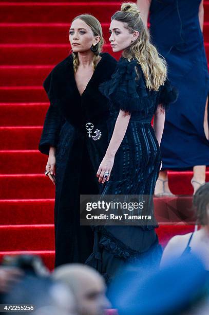 Actresses Mary-Kate Olsen and Ashley Olsen enter the Metropolitan Museum of Art on May 4, 2015 in New York City.