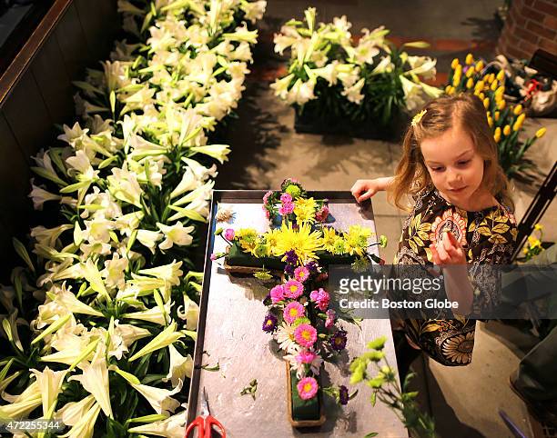 The Parish of the Epiphany made preparations for their three Easter Sunday masses by decorating the altar with flowers. Juliet Hollenbeck from...